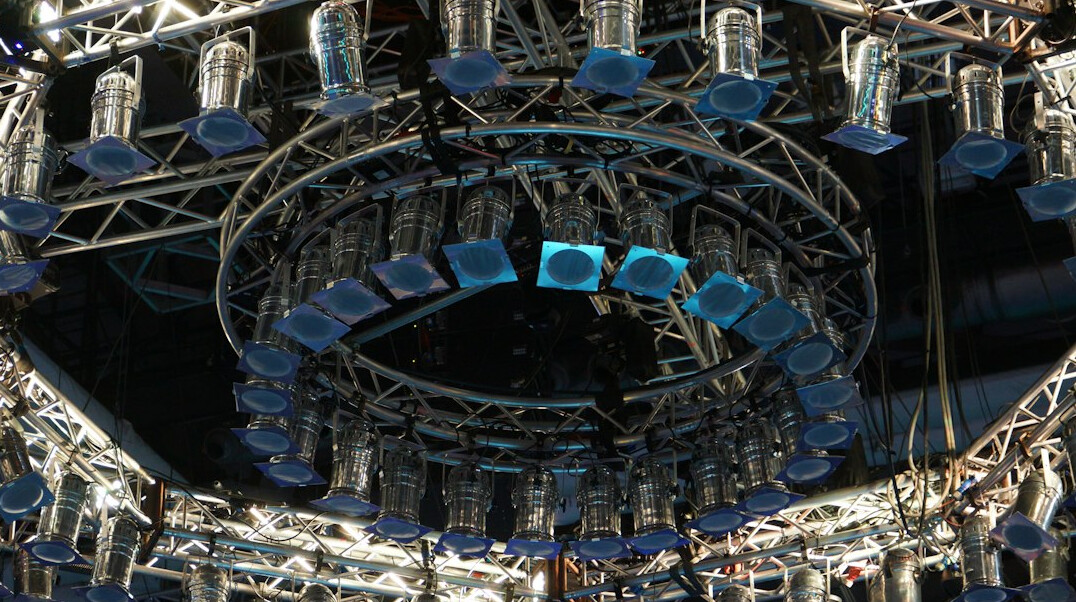 Overhead stage lighting rig with multiple spotlights