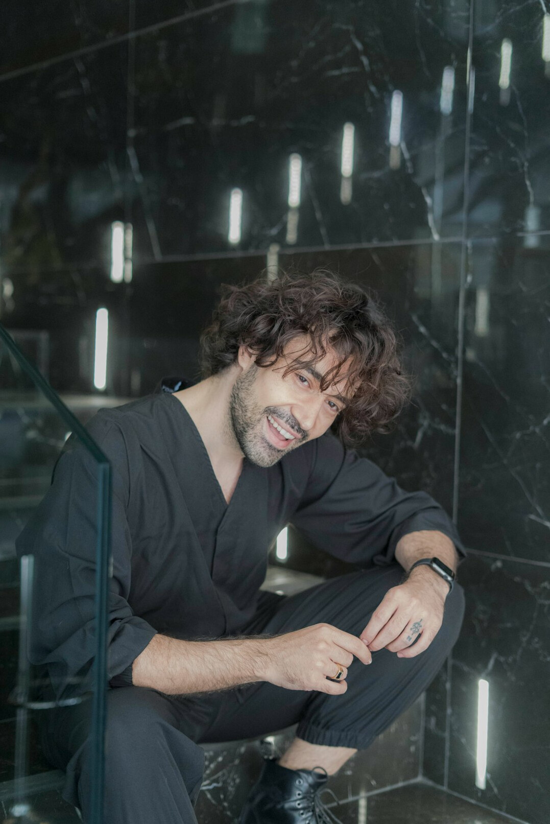 Portrait of a smiling bearded man in a dark shirt